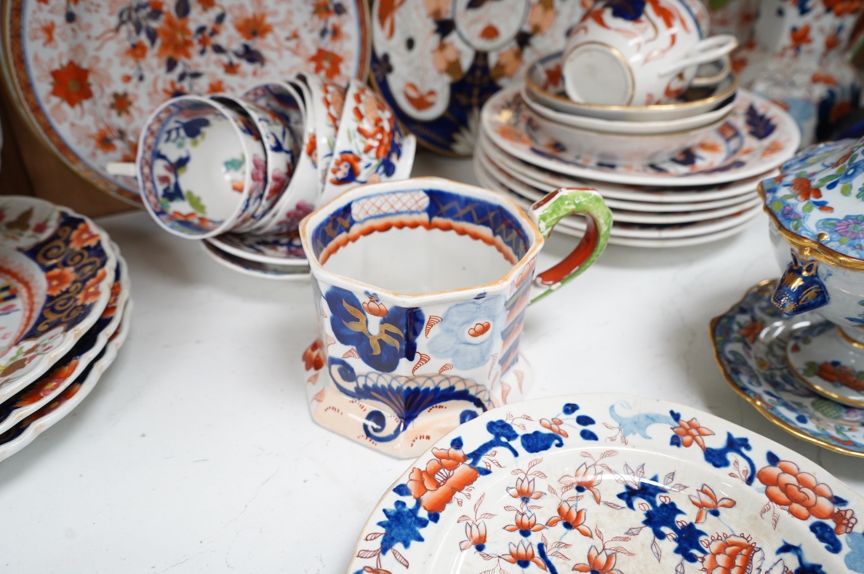 A collection of 19th century English ironstone china to include two pairs of sauce tureens, covers and stands, one marked Masons, various side plates and teacups